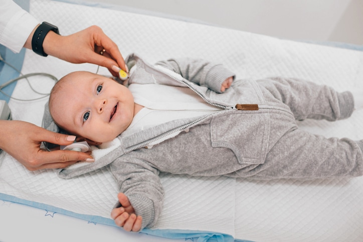 Baby having sensors placed for a hearing test