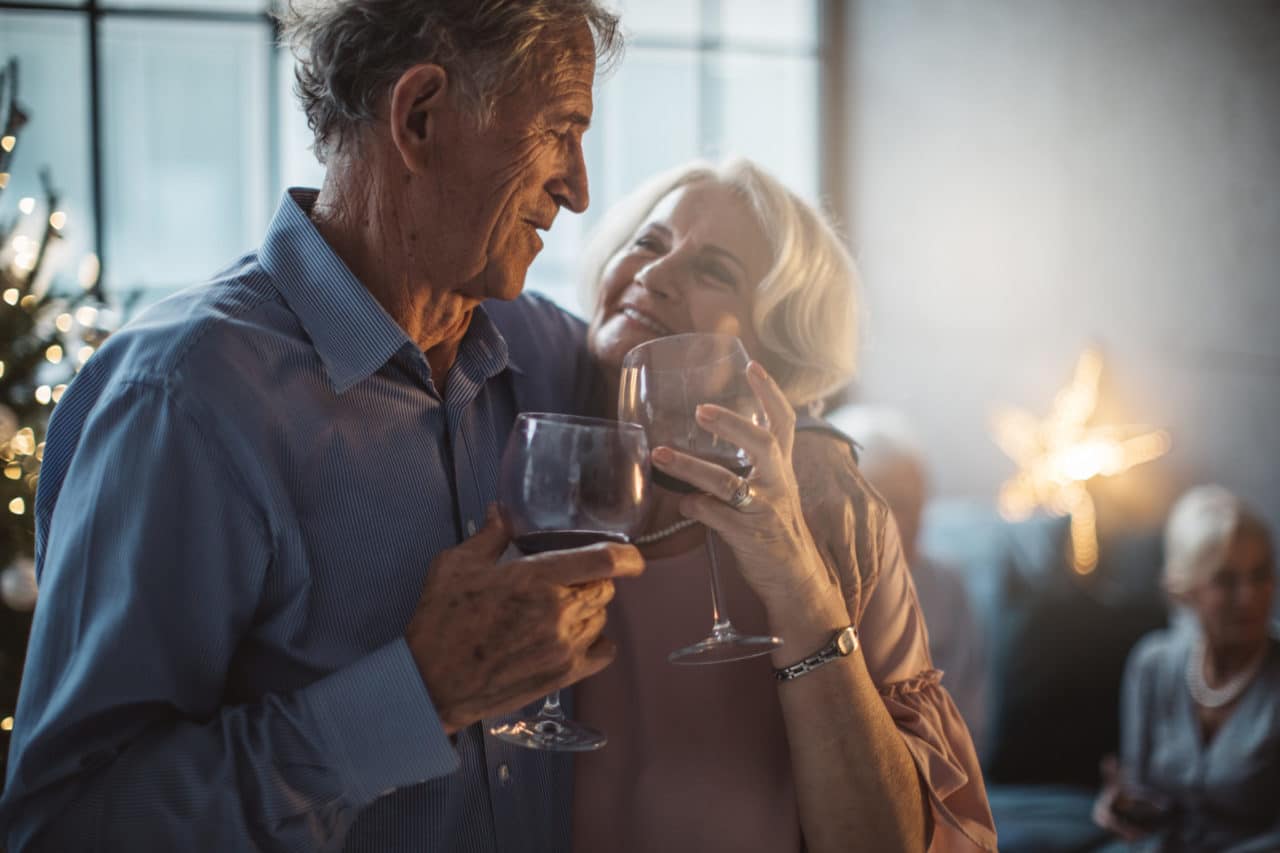 An older couple enjoying an evening with wine