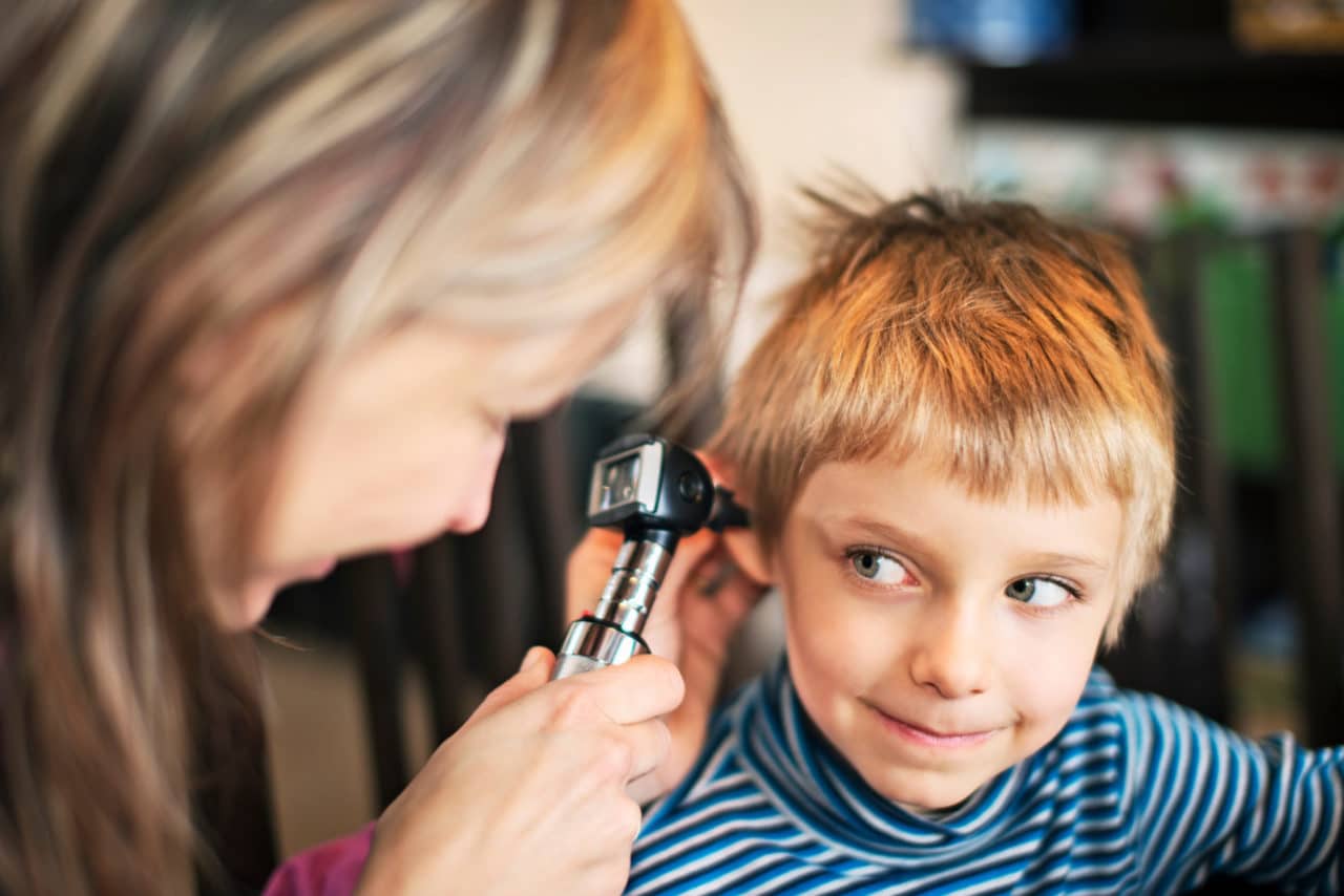 Child getting examined with an otoscope