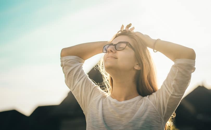 A woman breathing in outside.