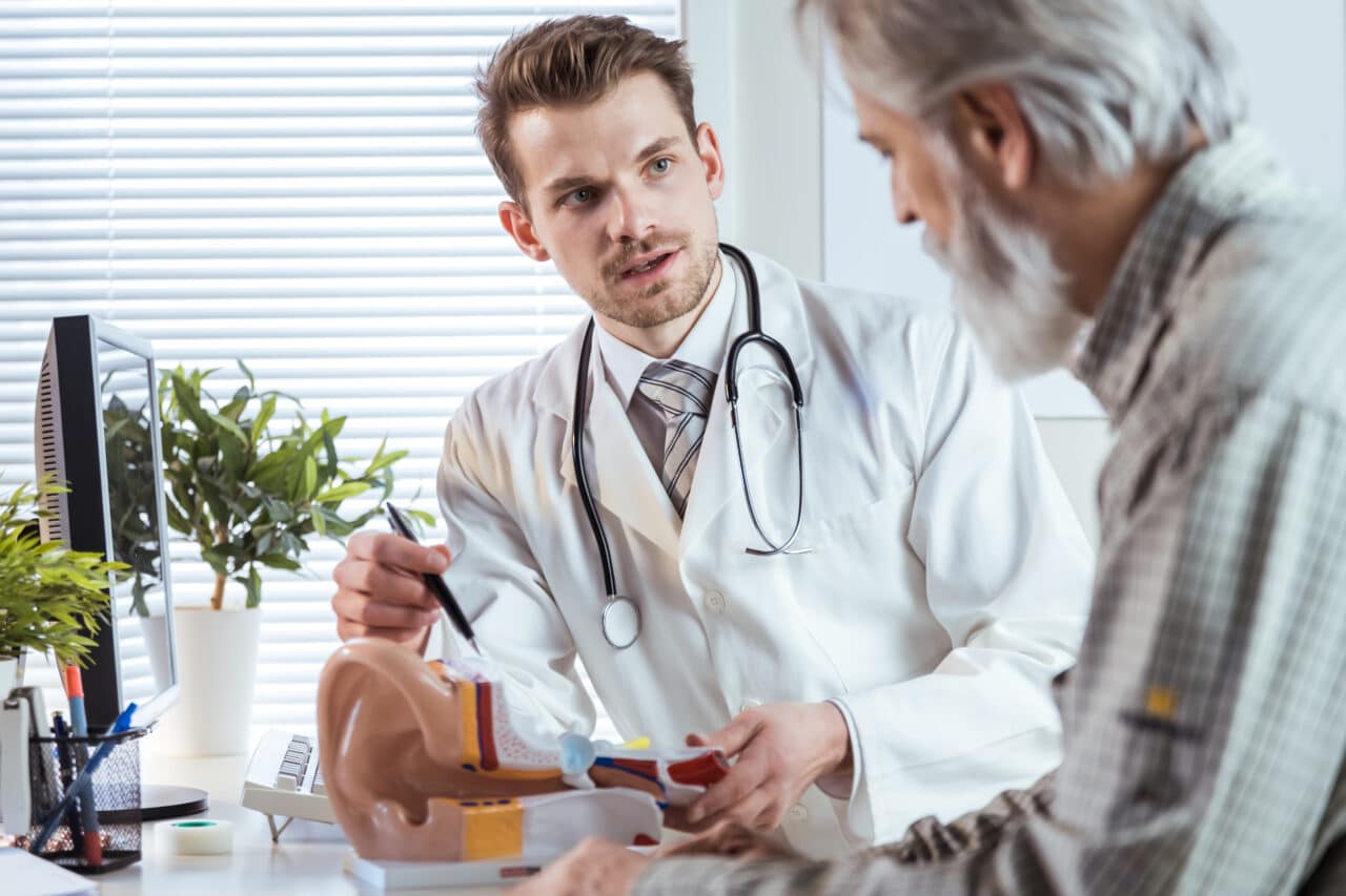 Audiologist talking with a patient about hearing loss.