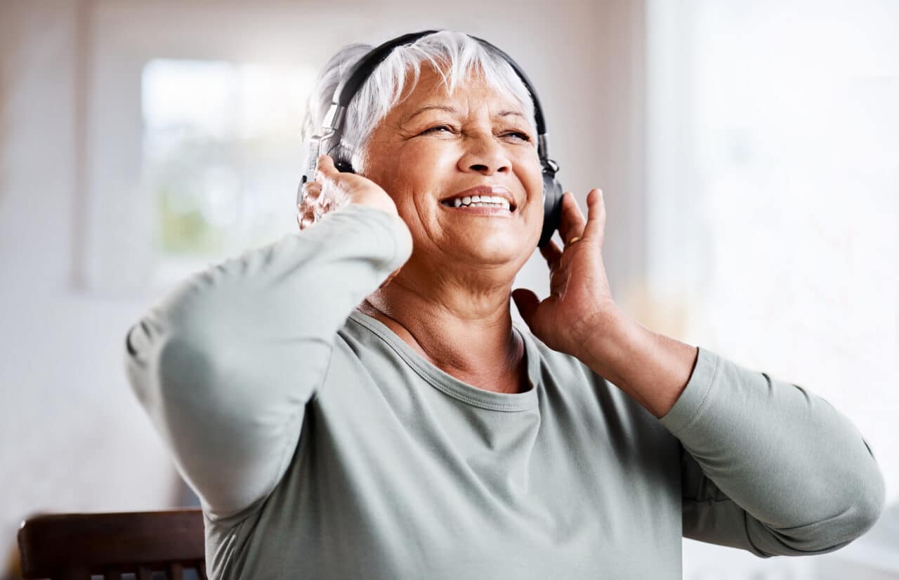 Older woman listening to music with headphones.