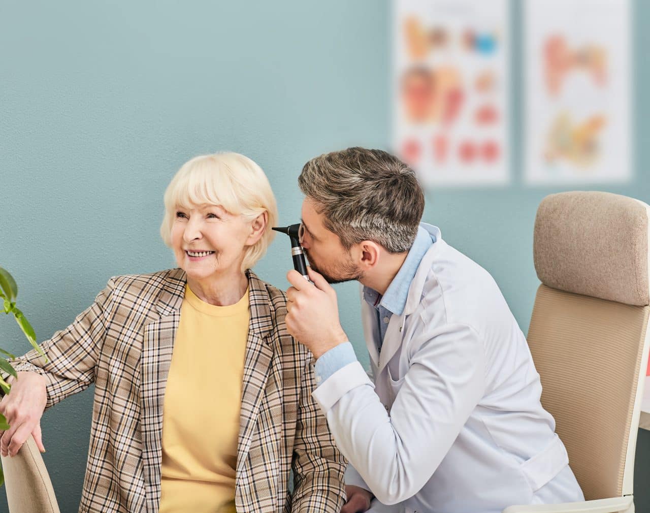 Smiling senior woman having her ears examined at a hearing clinic.