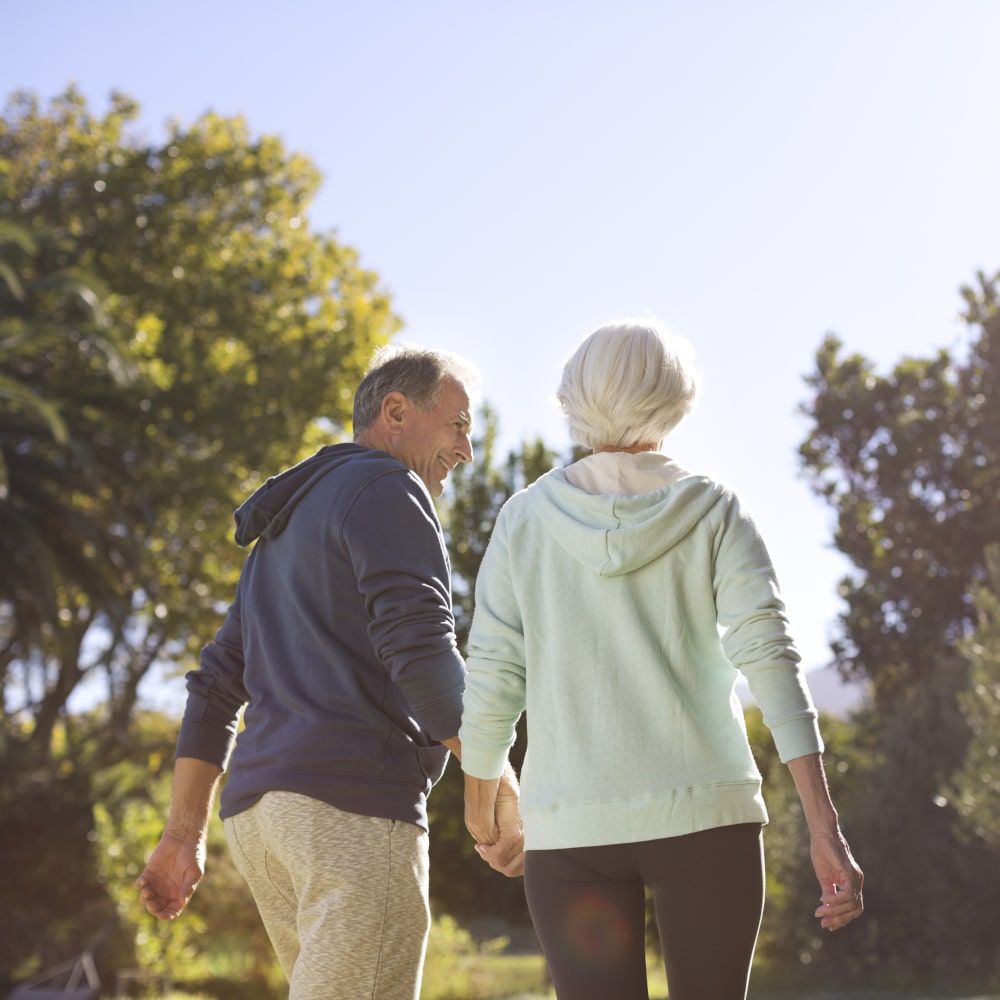 an older couple goes for a walk outdoors