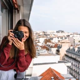 Female tourist taking a picture in a new city.