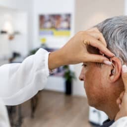 Man being fit for a hearing aid