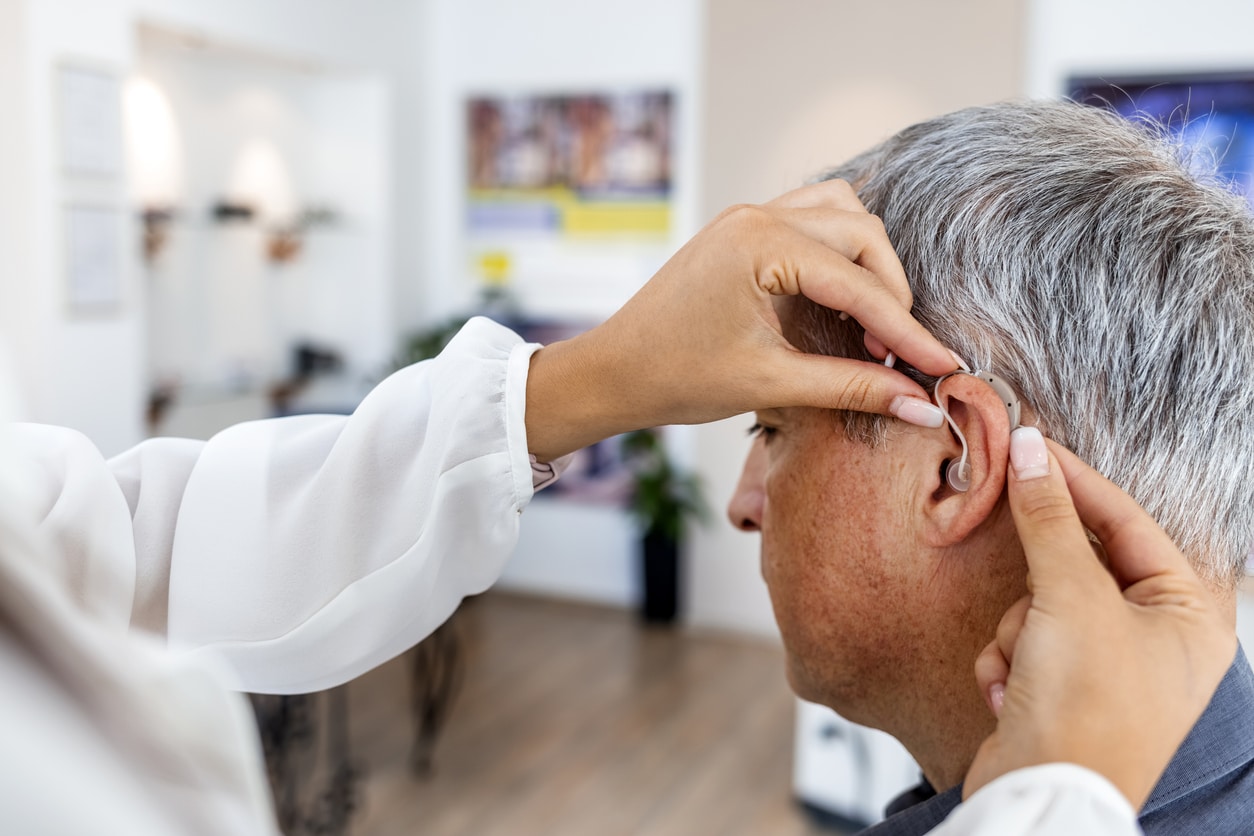 Man being fit for a hearing aid.