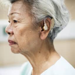 Profile view of a woman wearing hearing aids
