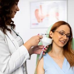 Woman having her ears cleaned at the doctor's office