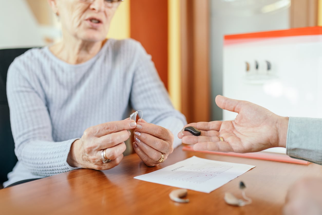 Senior woman looking at her hearing aid options.