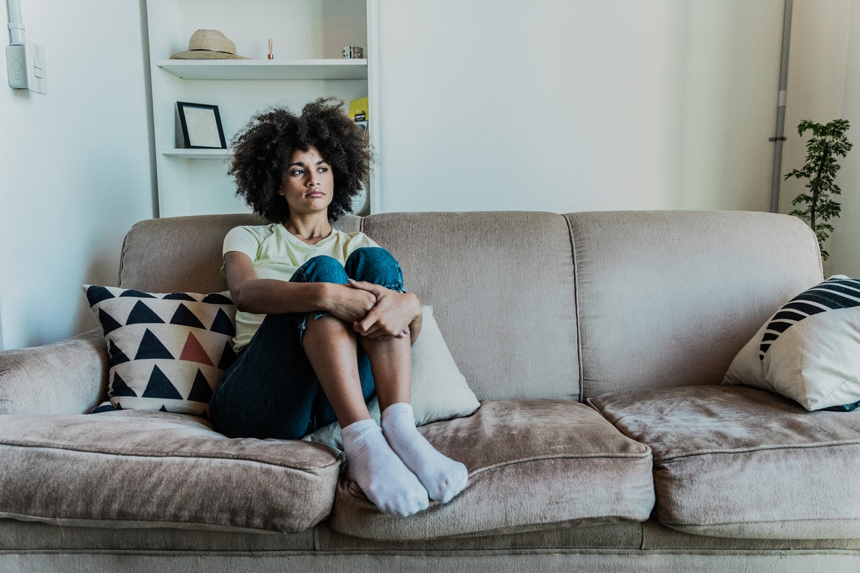 ad young woman looking away in the living room at home.