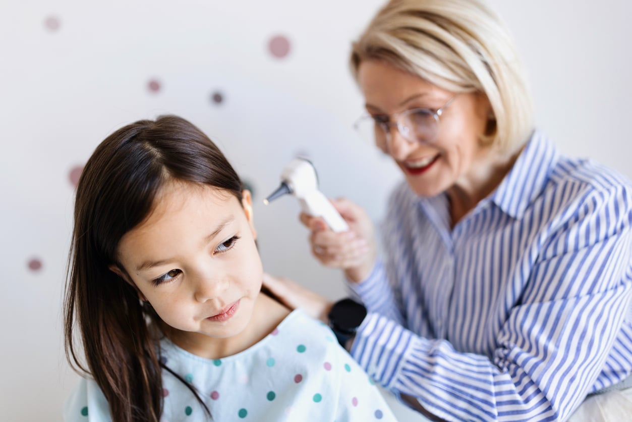 ENT looking in a young girl's ear.